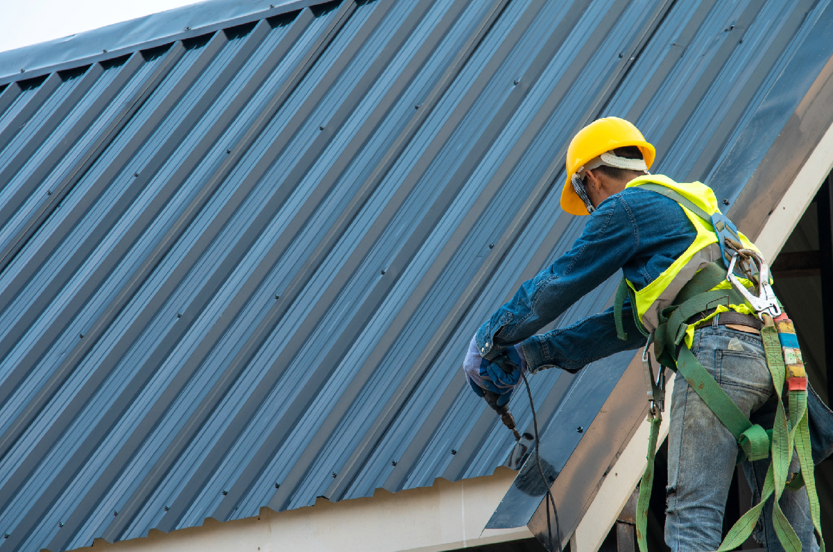 a roofer installing a metal roof